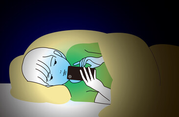 スマートフォンを夜間ベッドの中で見つめる男の子