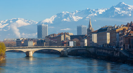 Fototapeta premium Image of cable cars over river and bridge in Grenoble in autumn, France.