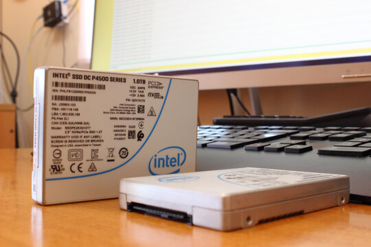 Sochi, Russia - September 24 2020: Intel server SSD NVMe disk with U.2 connector on table with computer display and keyboard on background