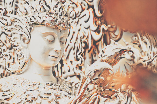 Exquisite design detail of a meditative deity-like statue carved inside the White temple in Thailand