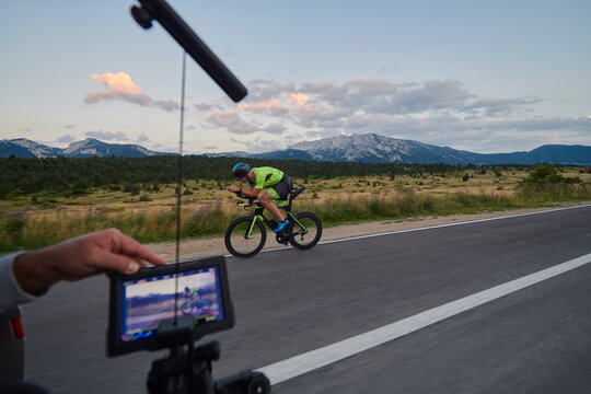 cinematographer taking action shot of triathlon bike athlete