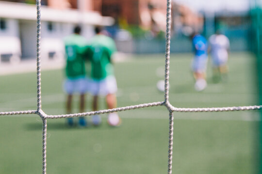 Goal and soccer players during a soccer match