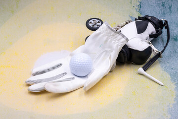 Golf ball is on golf glove on light background