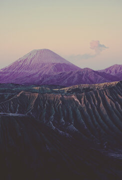 The steaming crater of Mount Bromo, Mount Semeru and stately Mount Batok in Java, Indonesia