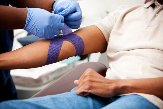 Blood Bank: Nurse Puts Bandage on Donor Arm