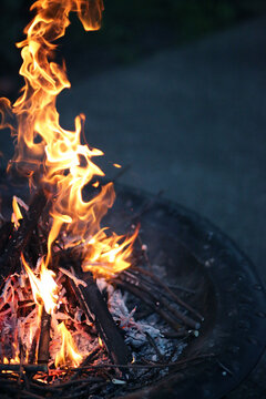 A Small Backyard Fire Burns Brightly On A Summer Evening