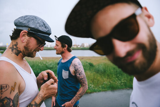 Three tattooed men hanging out