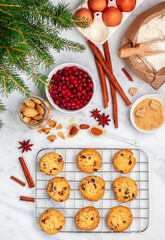 Naklejka na ściany i meble Freshly baked homemade Christmas cookies with cranberries, almonds, white chocolate, cinnamon and star anise. Delicious festive biscuit. Gingerbreads. Selective focus