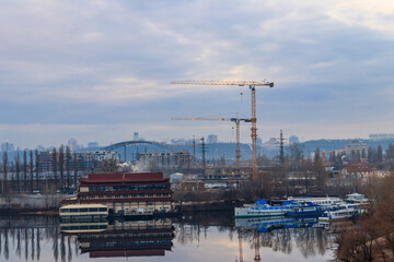 View of the Dnieper river and construction cranes on right bank in Kiev, Ukraine