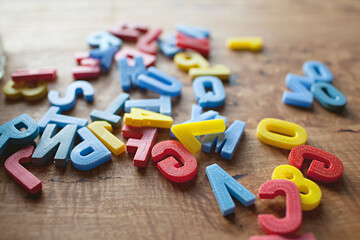 vintage children's letters and numbers arranged on a wooden table