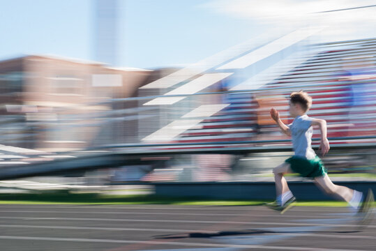 young boy sprints in a running race