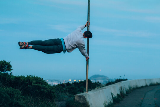 Young gymnast controls a sideways handstand