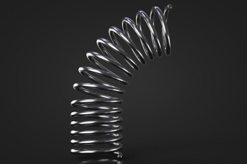 The metal coil spring is bent. Dark background. Close-up.