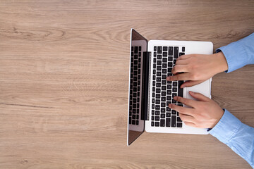 One hands typing on the computer keyboard