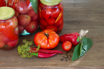 Preserves vegetables in glass on wood background, marinated fermented and pickled fermer food