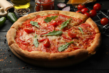 Tasty pizza and ingredients on wooden background