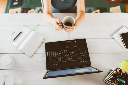 Anonymous Woman Drinking Coffee At The Home Office