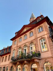 Balcony covered in flowers with big windows on an historic house during sunny day in Germany, Europe