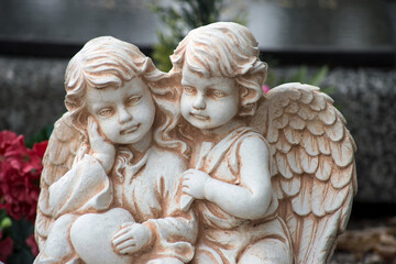 Closeup of stoned angels on tomb in a cemetery