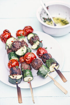 Food: grilled and marinaded zucchini meatballs tomato skewers