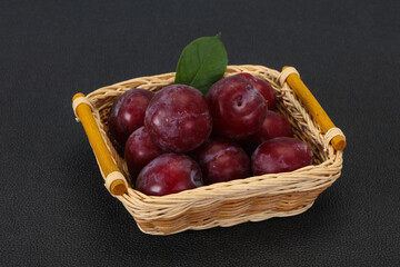 Plum heap in the wooden basket