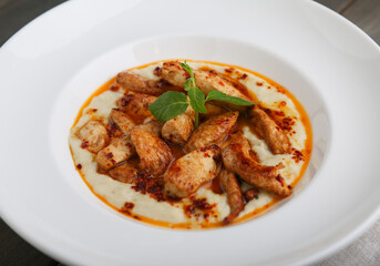 Chicken saute on mashed potatoes close up