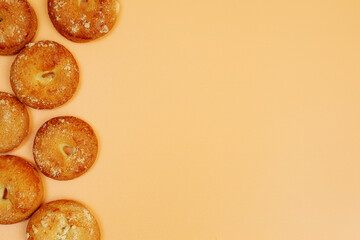frame composed of round cookies on yellow background