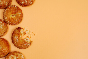 frame composed of round shortcake brown cookies on yellow background
