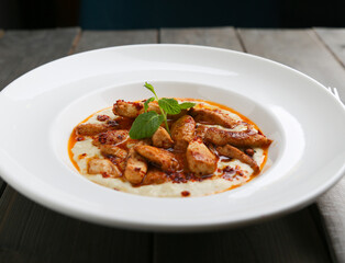 Chicken saute on mashed potatoes horizontal view