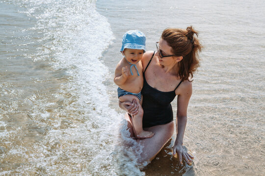 One year ol baby boy and his mother at Hendaye Beach in the south of France