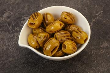 Green grilled olives in the bowl