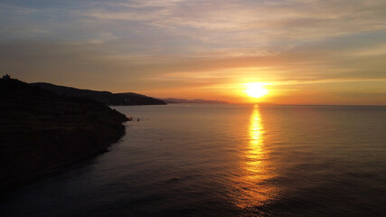 Fototapeta premium Sunrise on the sea from the air