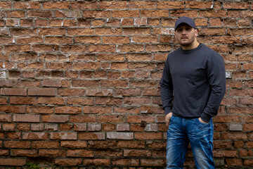 Man on the background of a red brick wall.