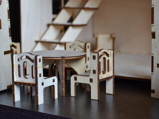 A toy miniature dining room made of wood for a doll house.