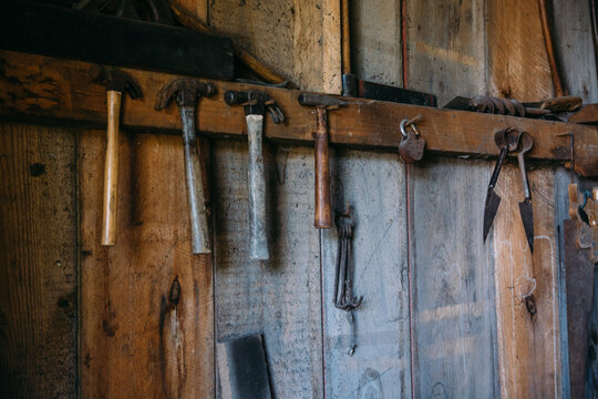 Old Hammers Hanging on a Wooden Wall in a Wood Shop