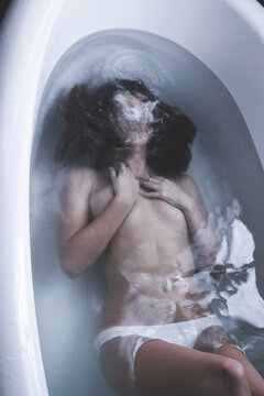 girl in bathtub with body underwater