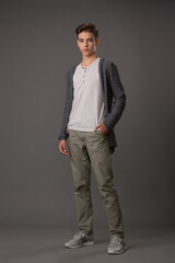 Handsome teen guy in grey cardigan and white tank top