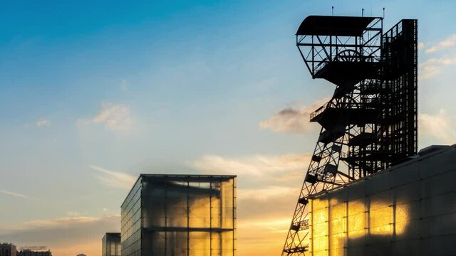 Coal mine of Katowice transformed into a modern center of culture - golden hour - time lapse zoom out shot