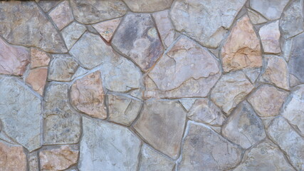 decorative stone cladding in a fragment of interior or exterior design using natural lightly processed large cobblestone