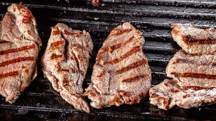 American cuisine. Fried pork in a cast iron skillet with stripes.
