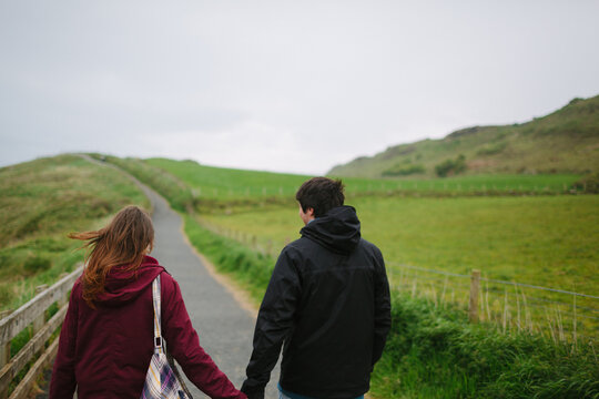 Young Couple Visiting Rocky Island . Northern Ireland