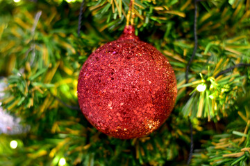 Closeup of Christmas Ball on Christmas Tree with bokeh beautiful background for design and decoration, new year concept, selective focus.