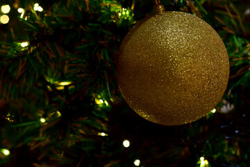 Closeup of Christmas Ball on Christmas Tree with bokeh beautiful background for design and decoration, new year concept, selective focus.