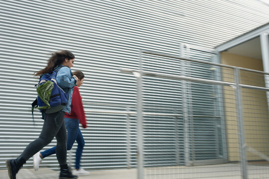 Two students arriving late at school