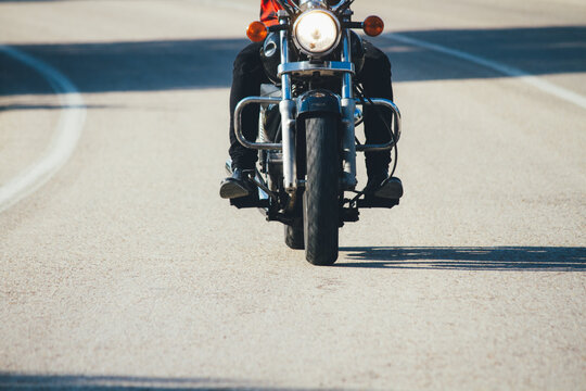 Man driving a motorbike on a road during a sunny day