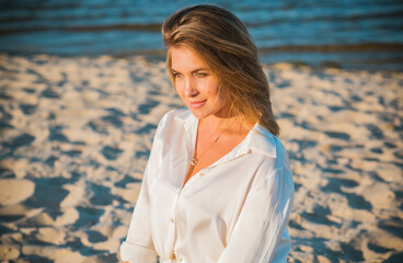 Relax time, elegant woman rest at beach. Nice femininity blonde hair lady, tranquility and freedom concept