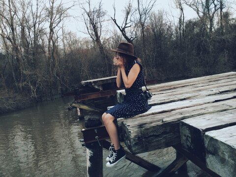 Woman Playing Harmonica on Bridge