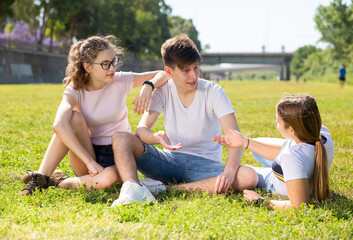 Fototapeta premium Portrait of positive teenagers on the summer green lawn