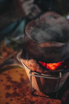 Traditional noodle soup served over a hot pot of glowing embers in Thailand.
