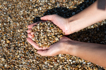 Small pebbles in the palms of a person.